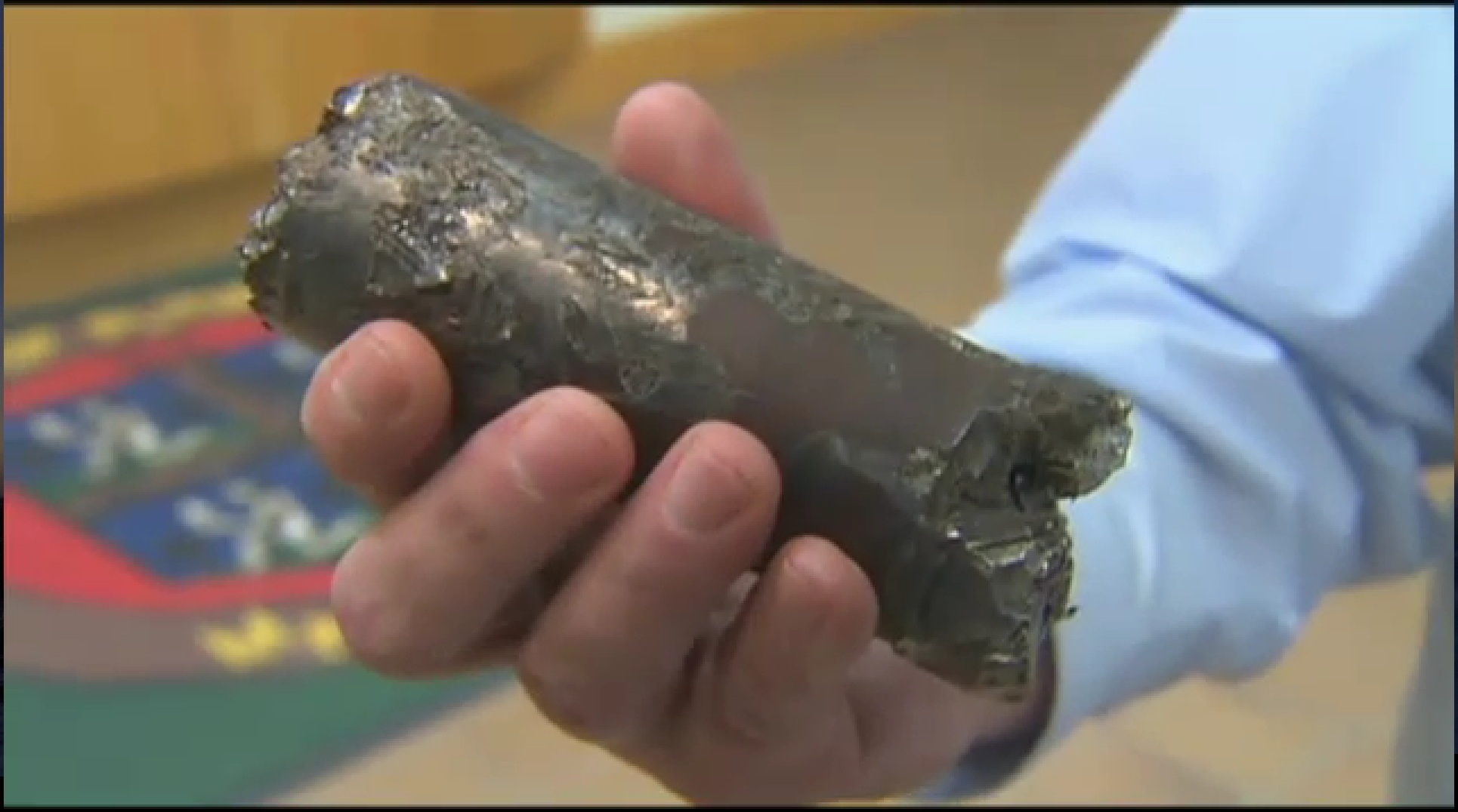 Captured video image of the metallic object which fell out of the sky in Plymouth MA. penetrating a roof.